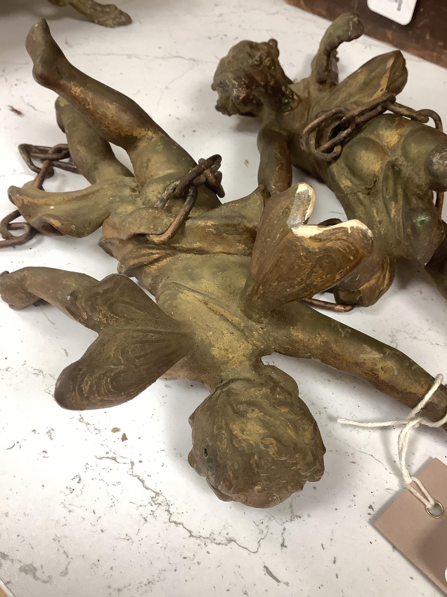 A pair of gilt metal cherub hanging figures, 26cm